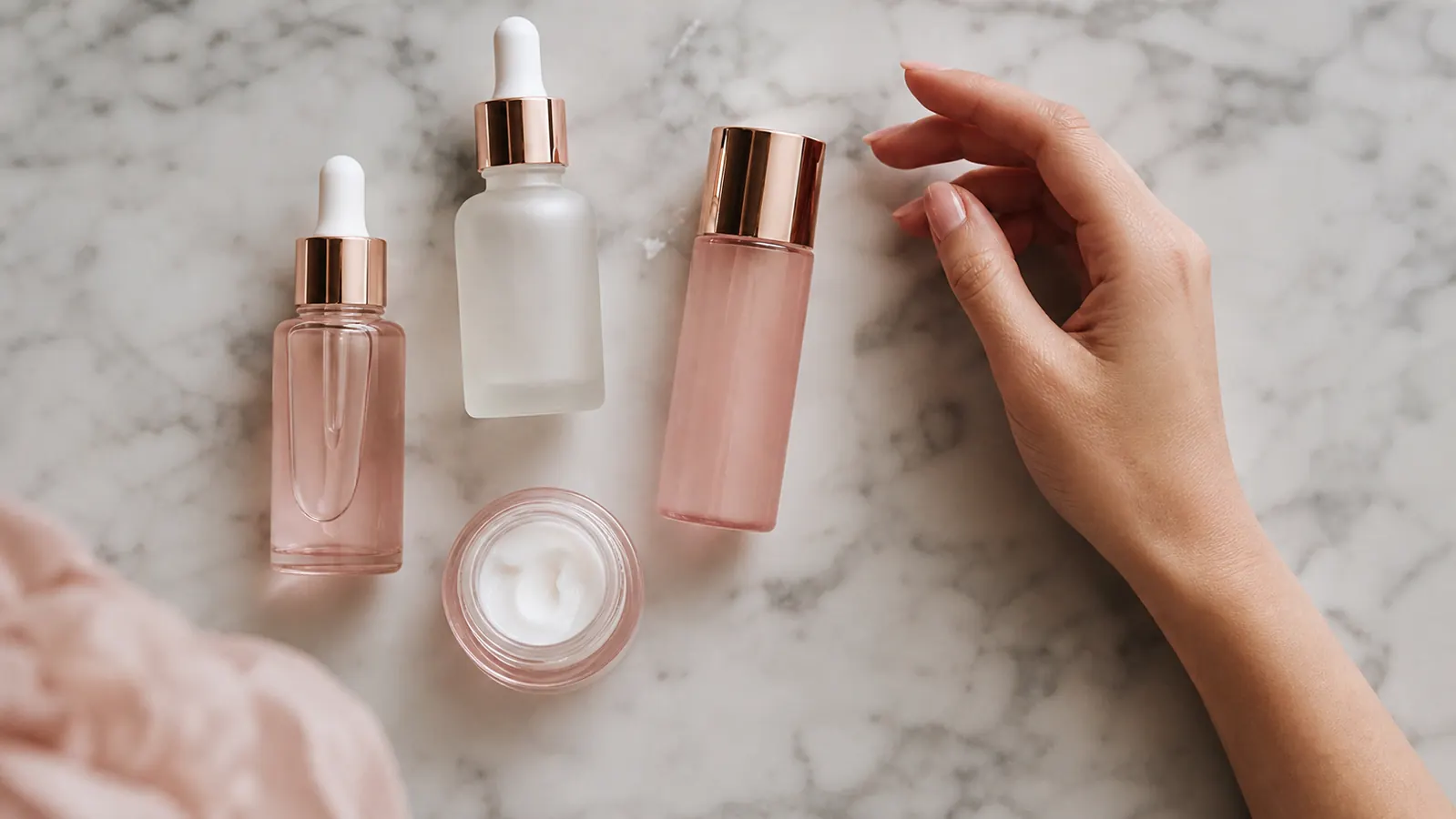 Overhead flat lay of a K-beauty skincare shelf with multiple PDRN products, soft natural light